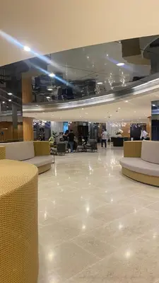 a lobby with couches and tables in a building at CASA ROSITA Staycation by 3MR in Manila