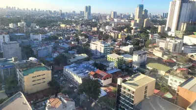 an overhead view of a city with tall buildings at Richard's Pad in Manila