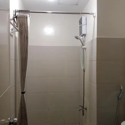 a bathroom with a shower with a shower curtain at Sweet Stay at Manila in Manila
