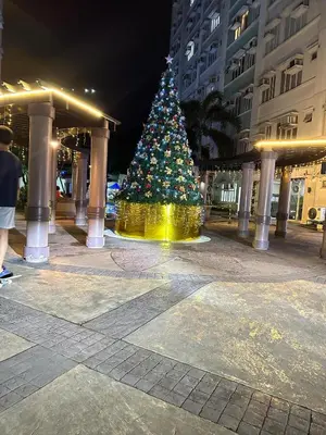 a christmas tree in the middle of a street at Sweet Stay at Manila in Manila