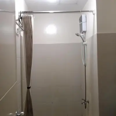 a bathroom with a shower with a shower curtain at Sweet Stay at Manila in Manila