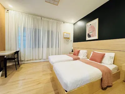 a hotel room with two beds and a table at MUJI TOWNHOUSE SUITE in Central Makati BILLIARDS, KTV in Manila