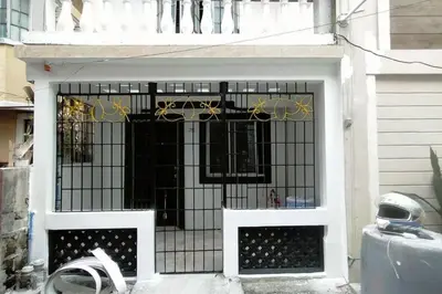 a door with a wrought iron gate on a house at 2BR ENTIRE Familyhome near NAIA,MOA,BGC in Manila