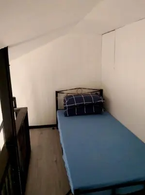 a bedroom with a blue bed in a room at 2BR ENTIRE Familyhome near NAIA,MOA,BGC in Manila