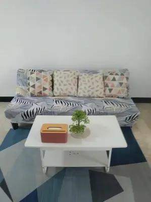 a living room with a couch and a white coffee table at 2BR ENTIRE Familyhome near NAIA,MOA,BGC in Manila