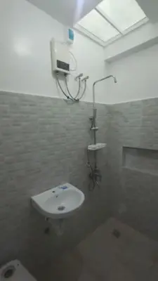 a bathroom with a white sink and a shower at 2BR ENTIRE Familyhome near NAIA,MOA,BGC in Manila
