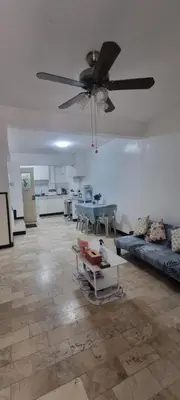a living room with a ceiling fan and a couch at 2BR ENTIRE Familyhome near NAIA,MOA,BGC in Manila