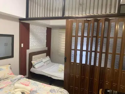 a bedroom with a bunk bed and a bed and a bunk bed at Ezekiel's Suites in Manila
