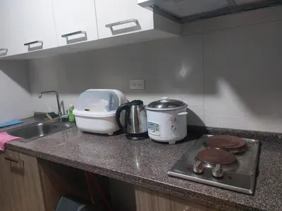 a kitchen counter with a toaster and a appliance on it at Ezekiel's Suites in Manila