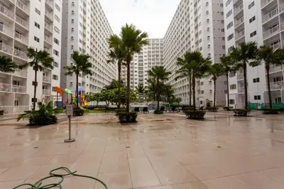 a courtyard with palm trees and tall buildings at Shore Residences Tower D - 2 Bunkbed Ideal for 6 guests in Manila
