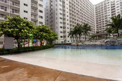 a swimming pool in the middle of two tall buildings at Shore Residences Tower D - 2 Bunkbed Ideal for 6 guests in Manila