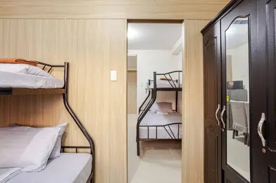 a small room with two bunk beds and a mirror at Shore Residences Tower D - 2 Bunkbed Ideal for 6 guests in Manila
