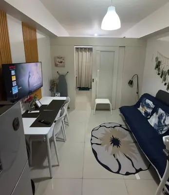 a living room with a couch and a table at Sea Residences Tower D, by Richnells in Manila