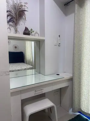 a white dressing table with a mirror and a stool at Sea Residences Tower D, by Richnells in Manila