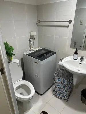 a bathroom with a toilet and a sink at Sea Residences Tower D, by Richnells in Manila