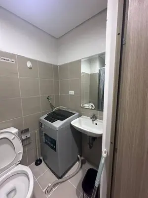 a small bathroom with a toilet and a sink at Sea Residences Tower D, by Richnells in Manila