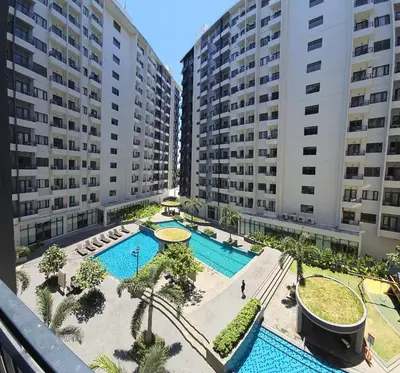 an aerial view of a pool with two buildings at SMDC Spring Resort Residences in Manila