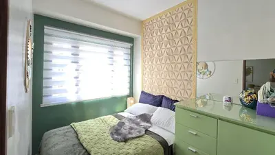 a bedroom with a cat laying on a bed at SMDC Spring Resort Residences in Manila