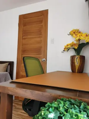 a table with a vase of flowers on top of it at Samong Transient House in Imus