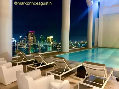 a pool with chairs and a view of the city at Rockwell View Acqua Iguazu Tower 17th flr Mandaluyong-Makati 1BR in Manila