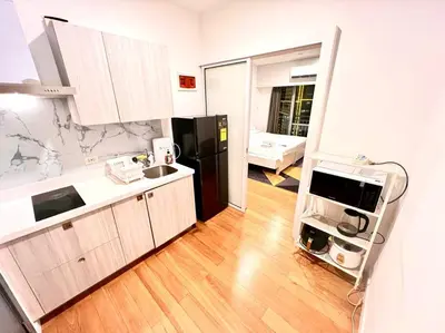 a kitchen with a black refrigerator and a sink at Rockwell View Acqua Iguazu Tower 17th flr Mandaluyong-Makati 1BR in Manila