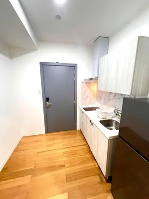 a kitchen with a refrigerator and a sink in it at Rockwell View Acqua Iguazu Tower 17th flr Mandaluyong-Makati 1BR in Manila