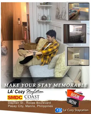a man sitting on a couch in a living room at Flat in Pasay-Coast Residences in Manila