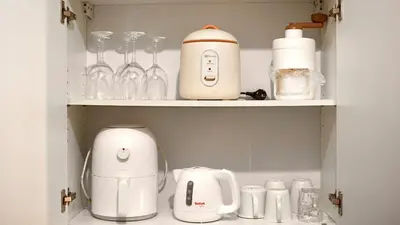 a cupboard filled with appliances on top at Venice Vista Lodge Staycation connected to Venice Grand Canal in Manila