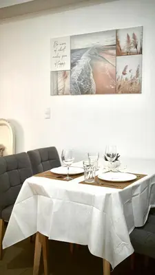a table with a white table cloth on it at Venice Vista Lodge Staycation connected to Venice Grand Canal in Manila
