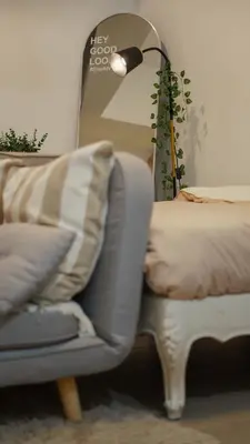 a living room with a couch and a lamp and a chair at Venice Vista Lodge Staycation connected to Venice Grand Canal in Manila