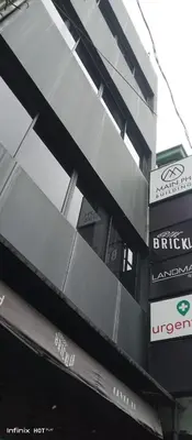 a building with a sign on the side of it at Cedar House in Manila