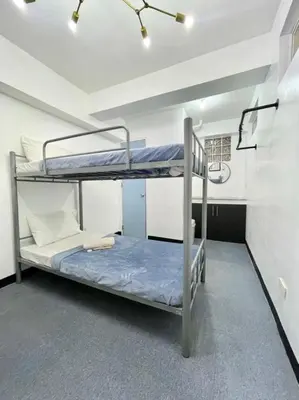 a bedroom with two bunk beds in a room at Cedar House in Manila