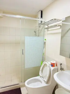 a bathroom with a shower and a toilet and a sink at \u9a6c\u5c3c\u62c9\u6e7e\u4e09\u623f\u516c\u5bd3 in Manila