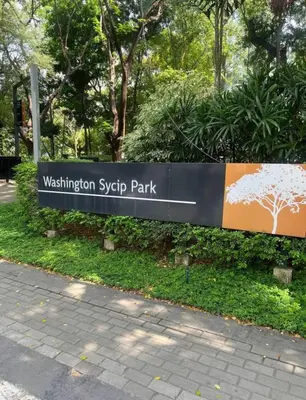 a sign for the washington system park in a park at Newly Renovated 2-Storey Loft at Greenbelt 1 in Manila