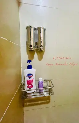 a shelf in a bathroom with a bottle of soap at EJ Homes - Shore 3 Residences in Manila