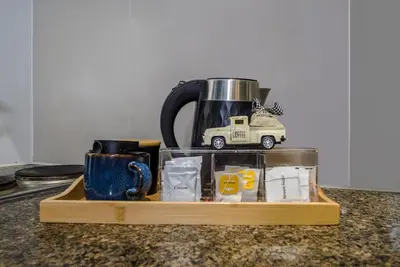 a wooden tray with a coffee pot and a toy truck at Vintage Mickey Disney Stay in BGC -200mbps wifi in Manila