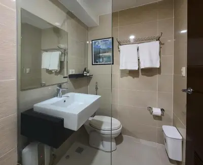 a bathroom with a sink and a toilet at Vintage Mickey Disney Stay in BGC -200mbps wifi in Manila