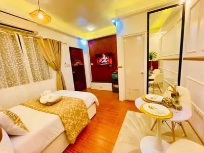 a hotel room with two beds and a table at Subway House in Paranaque in Manila