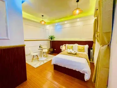 a bedroom with a large bed and a desk at Subway House in Paranaque in Manila