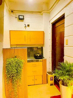 a kitchen with a wooden cabinet and a counter at Subway House in Paranaque in Manila