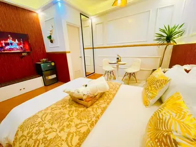 a hotel room with a large bed and a table at Subway House in Paranaque in Manila