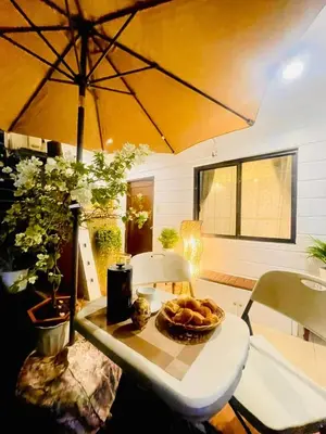 a table with a bowl of bread on it with an umbrella at Subway House in Paranaque in Manila