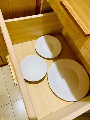 two white plates sitting on top of a wooden floor at Subway House in Paranaque in Manila
