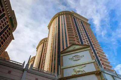 a tall building with a clock in front of it at Italian Style Unit in Venice Luxury Residences in Manila