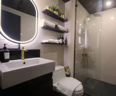 a bathroom with a white sink and a shower at Italian Style Unit in Venice Luxury Residences in Manila