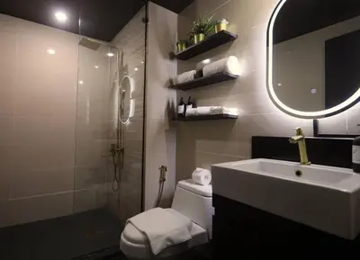 a bathroom with a sink and a toilet and a mirror at Italian Style Unit in Venice Luxury Residences in Manila