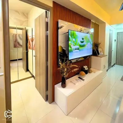 a living room with a flat screen tv and a aquarium at Crib2Go Benz Suite with Pool View in Manila
