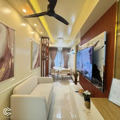 a living room with a couch and a flat screen tv at Crib2Go Benz Suite with Pool View in Manila