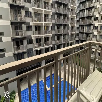 a balcony of a building with a swimming pool at Crib2Go Benz Suite with Pool View in Manila