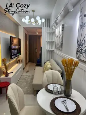 a living room with a couch and a table at Smdc Coast Residences- LA Cozy Staycation in Manila